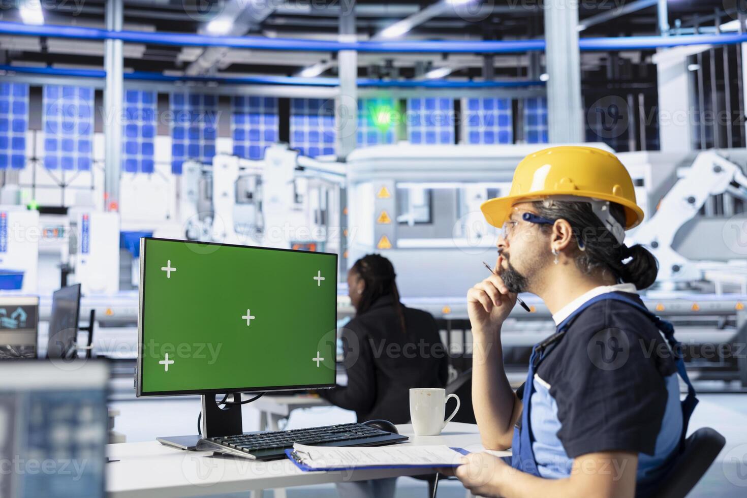 Technician in photovoltaics factory using green screen PC to improve solar panels assembly processes. Engineer using mockup computer to calibrate equipment for precise solar cells manufacturing photo