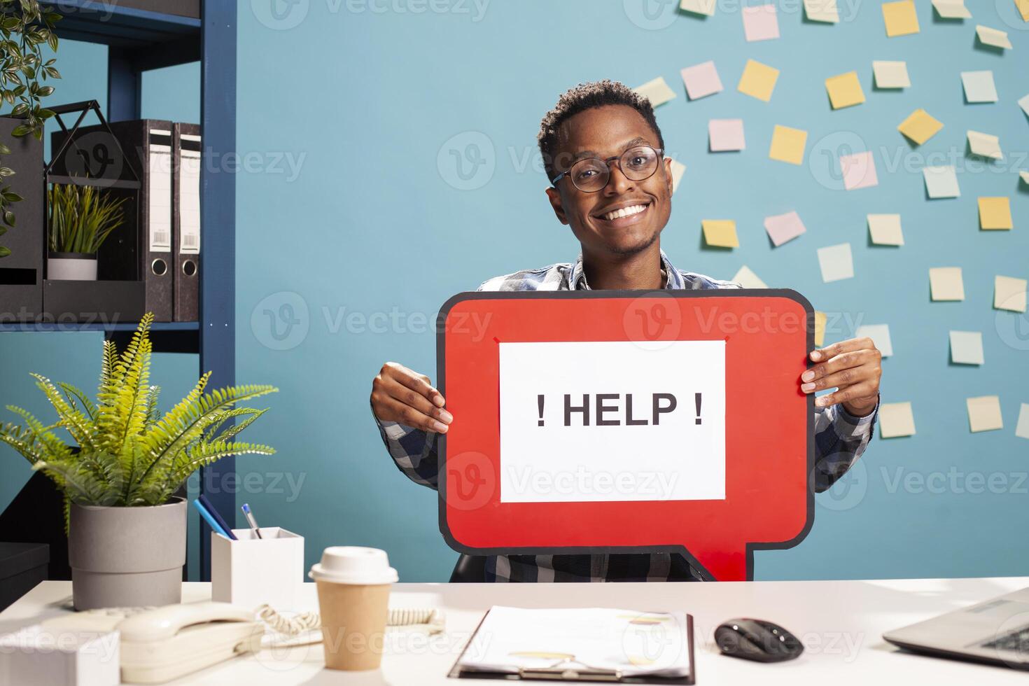 Smiling recruiter presenting a hiring message bubble, inviting job seekers to apply for position. Enthusiastic man holding a help signboard, promoting employment opportunities. photo
