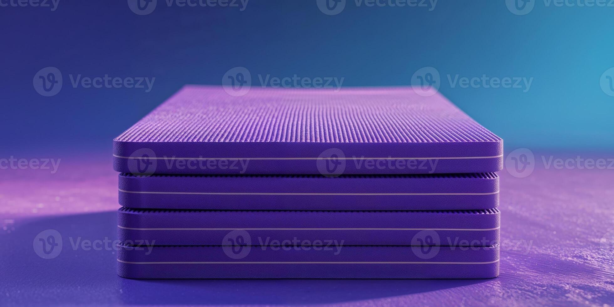 A stack of purple yoga mats on a blue background photo