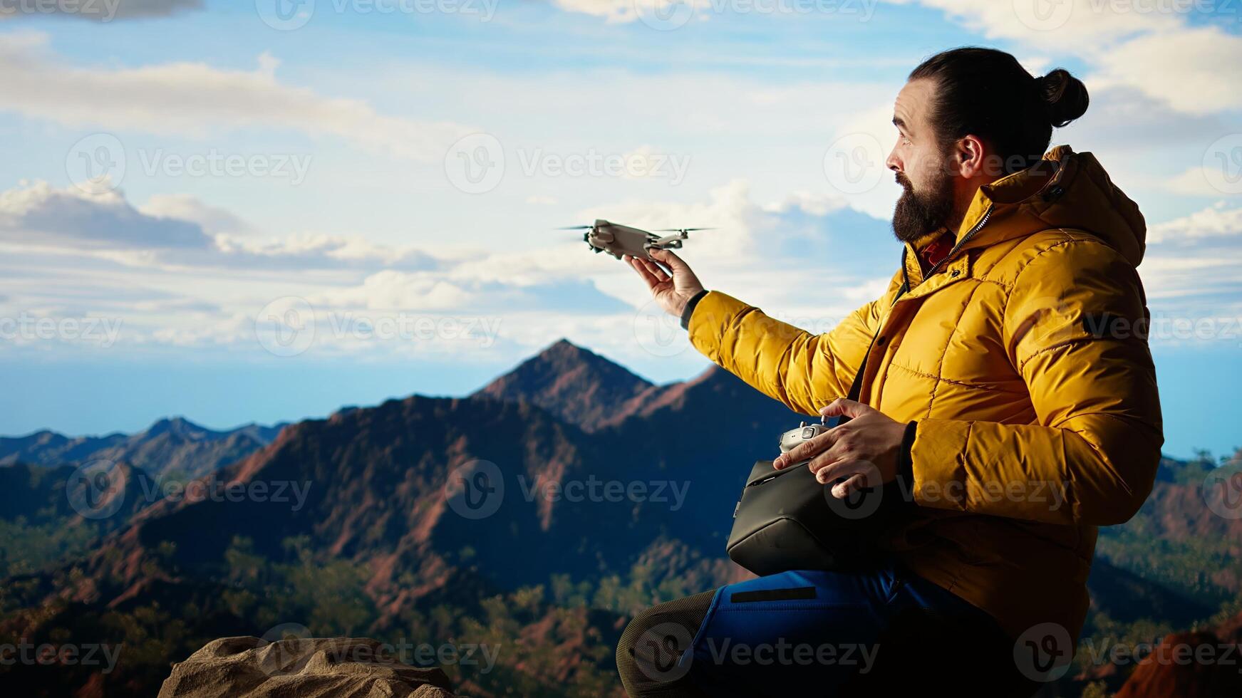 Trekking enthusiast captures his activity on using a drone footage, documenting the scenic mountain range valley. Filming beautiful aerial view vlog with remote control device. Camera A. photo