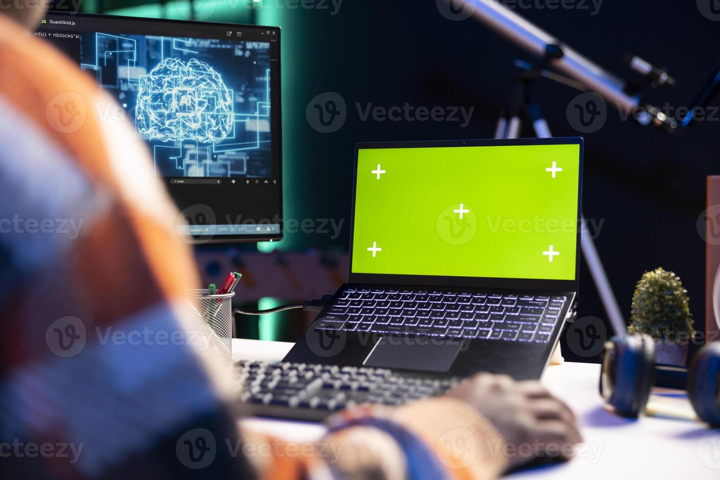 African american man using AI to develop a software system with chroma key on pc, cloud computing. Male IT programmer showing his skill in coding and cyber security, machine learning. photo