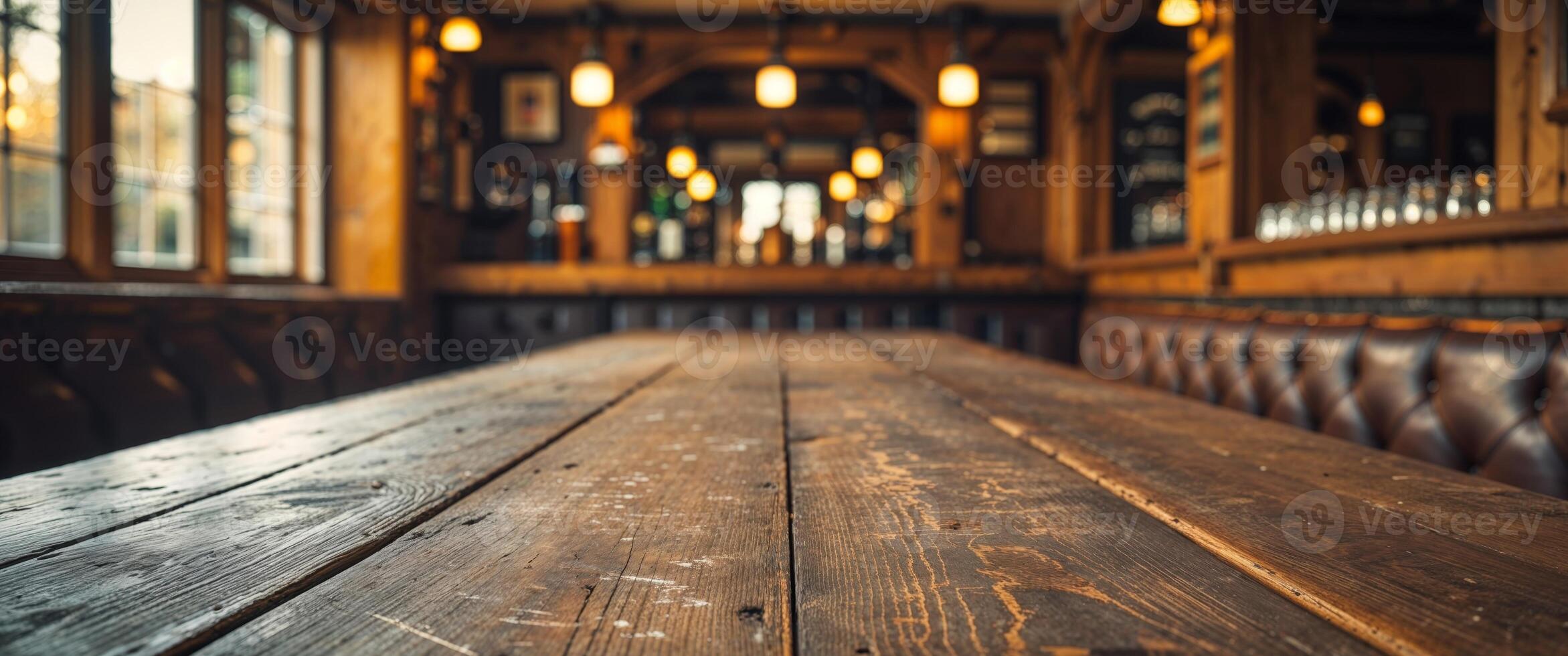 A wooden table in a pub with a bar photo