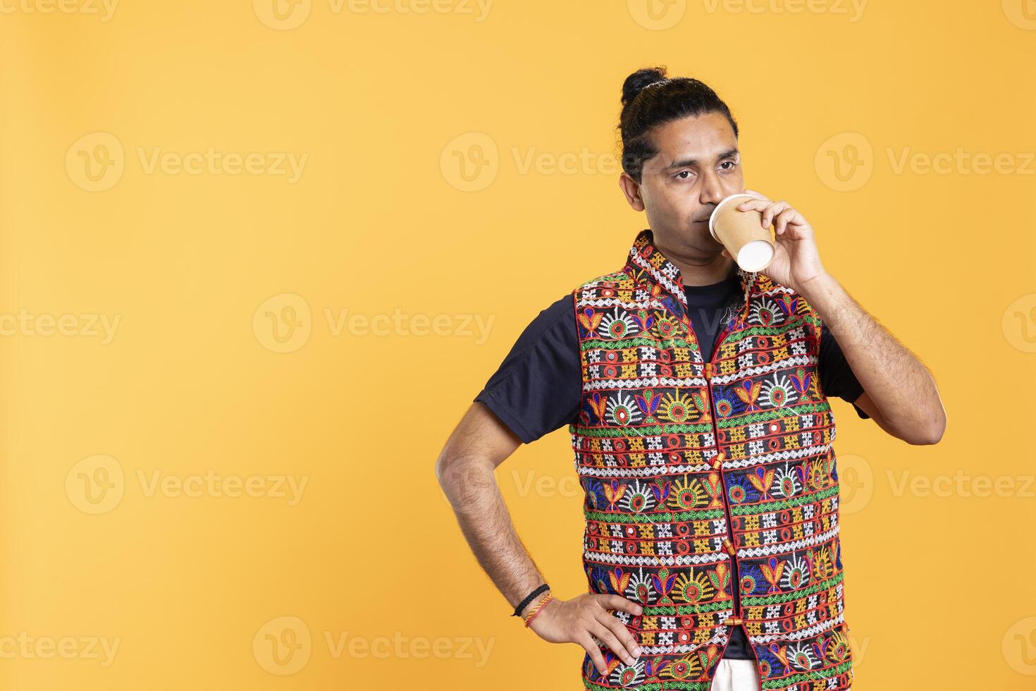 Sleepy man sipping coffee to wake up and gain energy, suffering from insomnia. Exhausted person feeling fatigued after sleepless night, drinking caffeinated beverage, studio backdrop photo