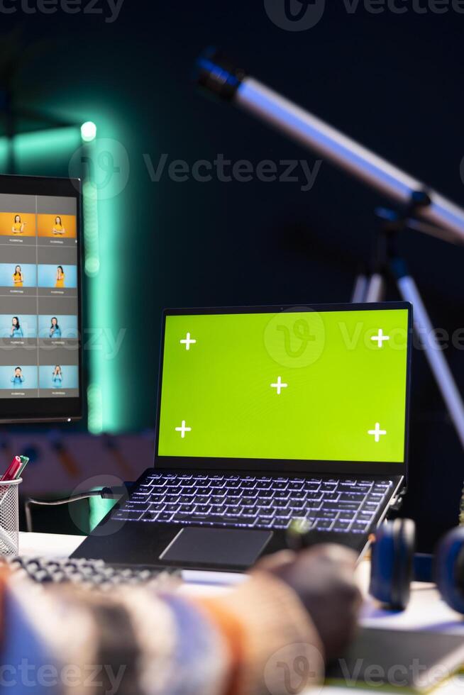Artistic designer using advanced tools for photo retouching next to chroma key at home office, representing the flexibility of a creative career in the tech industry. Expert editing a project.