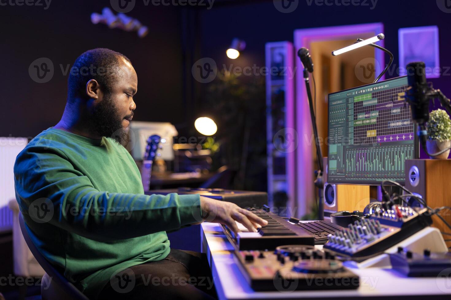 Modern producer playing piano keys to record a new soundtrack, trying to produce a song using midi controller electronic keyboard. Songwriter composer playing instrument notes to create tunes. photo