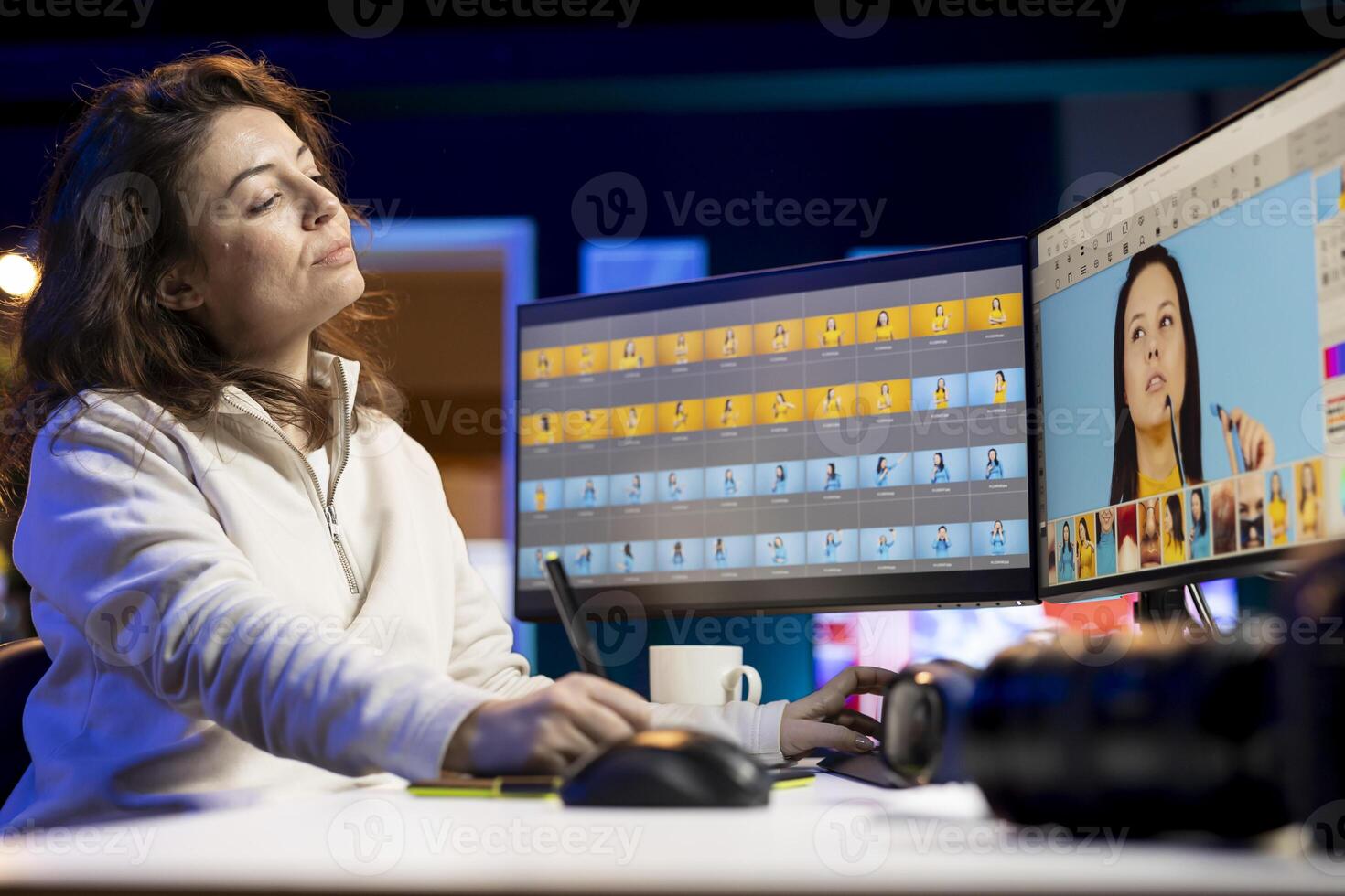 Photographer using photo editing software on PC display in multimedia creative studio, making adjustment on graphic tablet. Freelancer using retouching program on touchscreen device