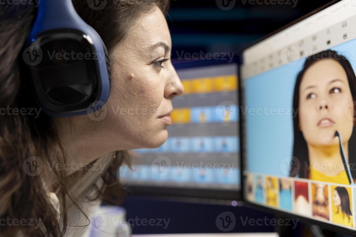 Content specialist selecting best editorial pictures for social media while listening music through headphones. Expert editing photos in advertising agency office, close up
