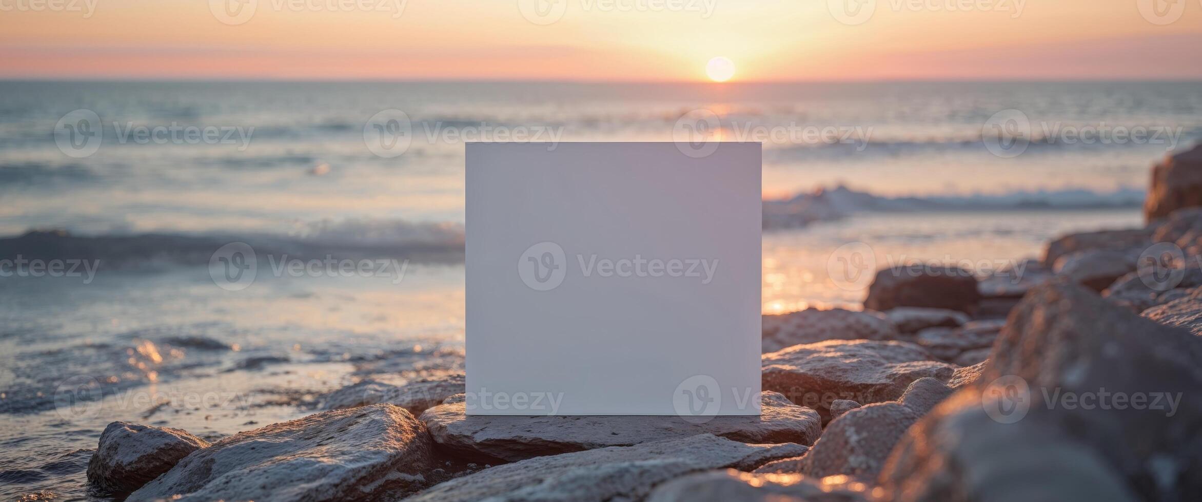 Blank white card on the beach at sunset photo