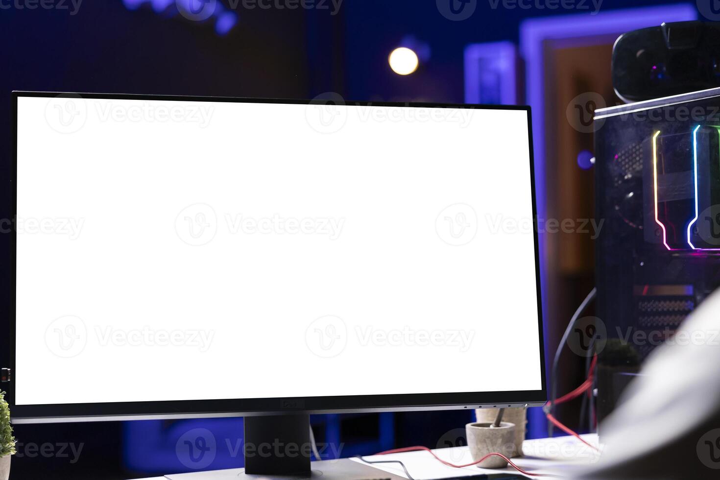 Man in dark living room playing videogames on mockup gaming PC monitor at computer desk during leisure time. Gamer battling enemies in online multiplayer game, close up on isolated screen display photo