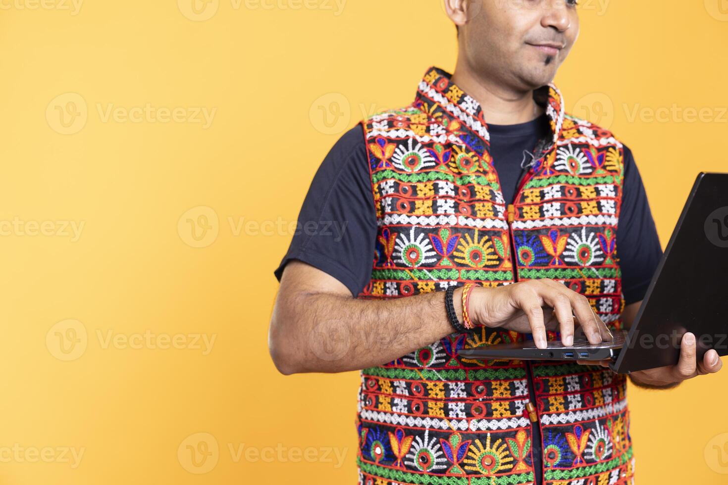 Worker typing on laptop, doing business related tasks, isolated over studio backdrop. Close up shot of person doing budgeting, forecasting, and financial analysis on notebook photo