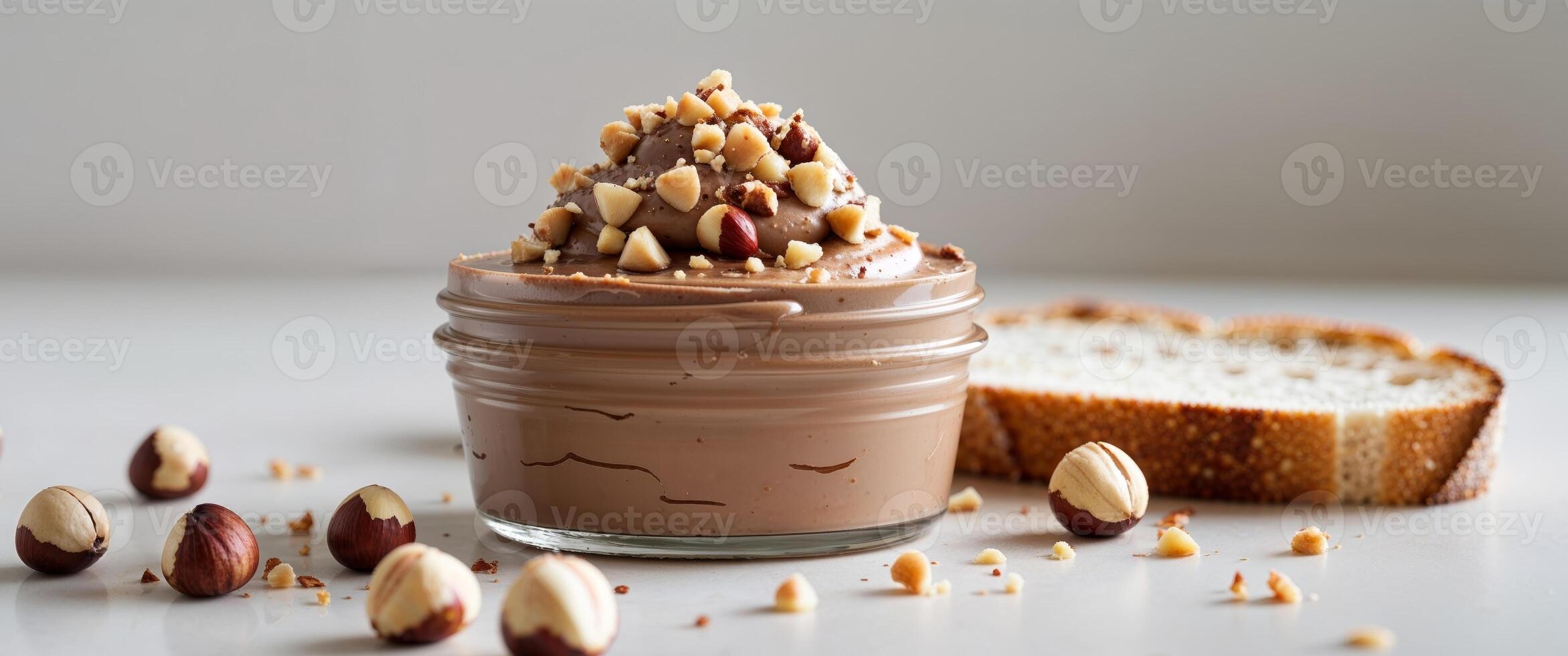A jar of chocolate pudding with nuts and bread photo