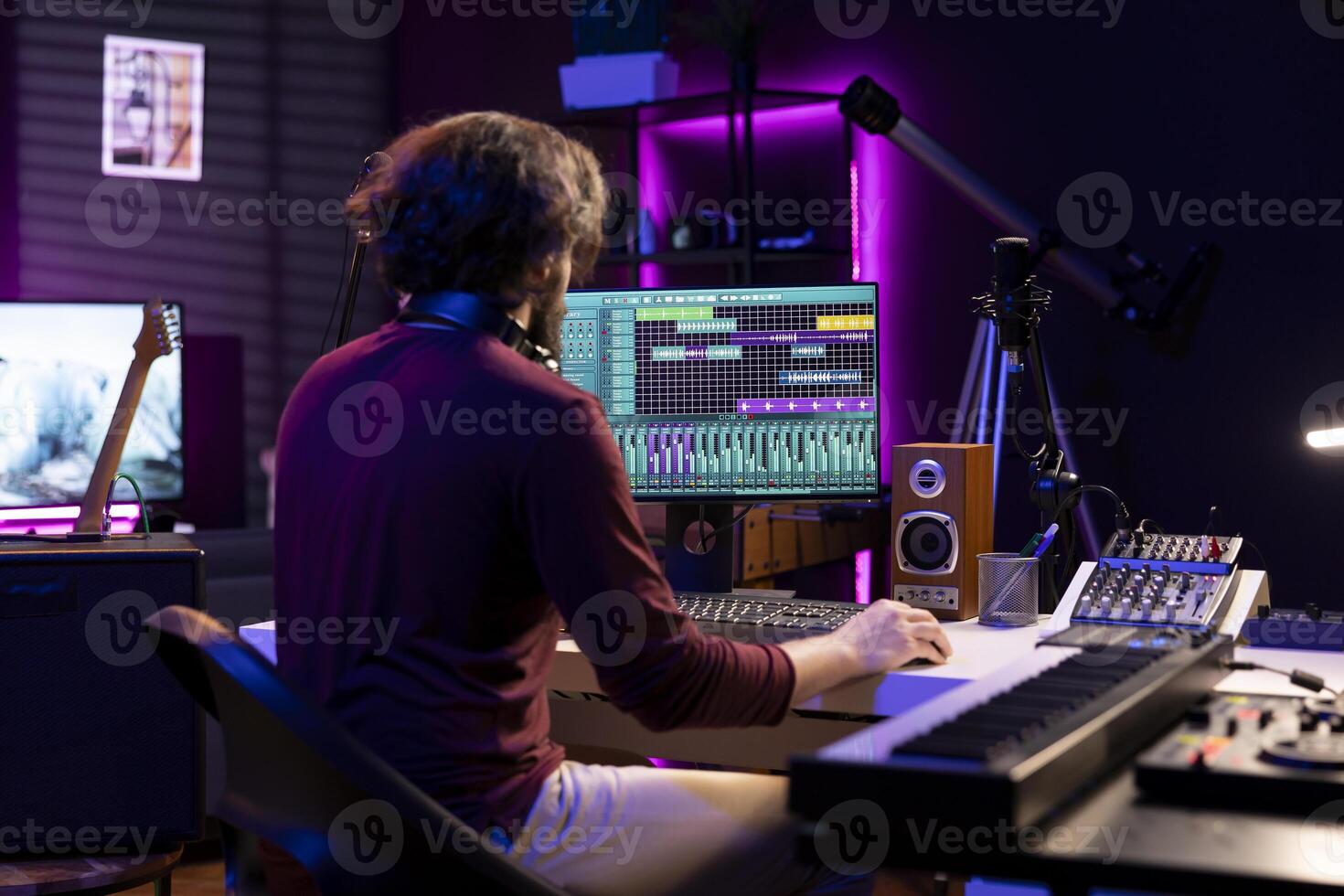 Sound engineer working in his home studio with daw software on computer and mixing tools, creating music. Producer mixing and mastering soundtracks, signal processing acoustical engineering. photo