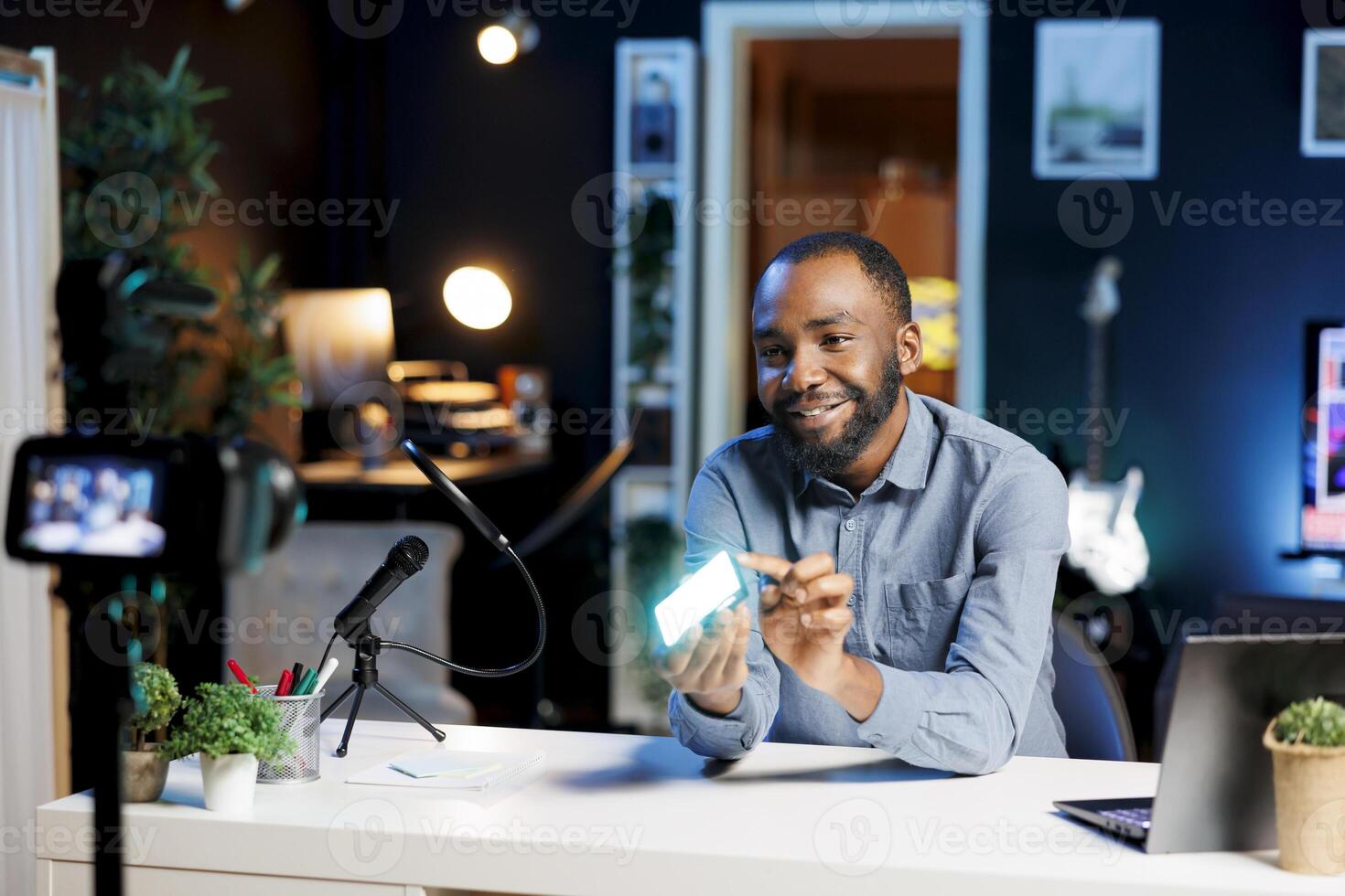 Cheerful media star being sponsored by partnering brand to do mini RGB lights unboxing content. Tech guru does influencer marketing, doing product placement of production tool photo
