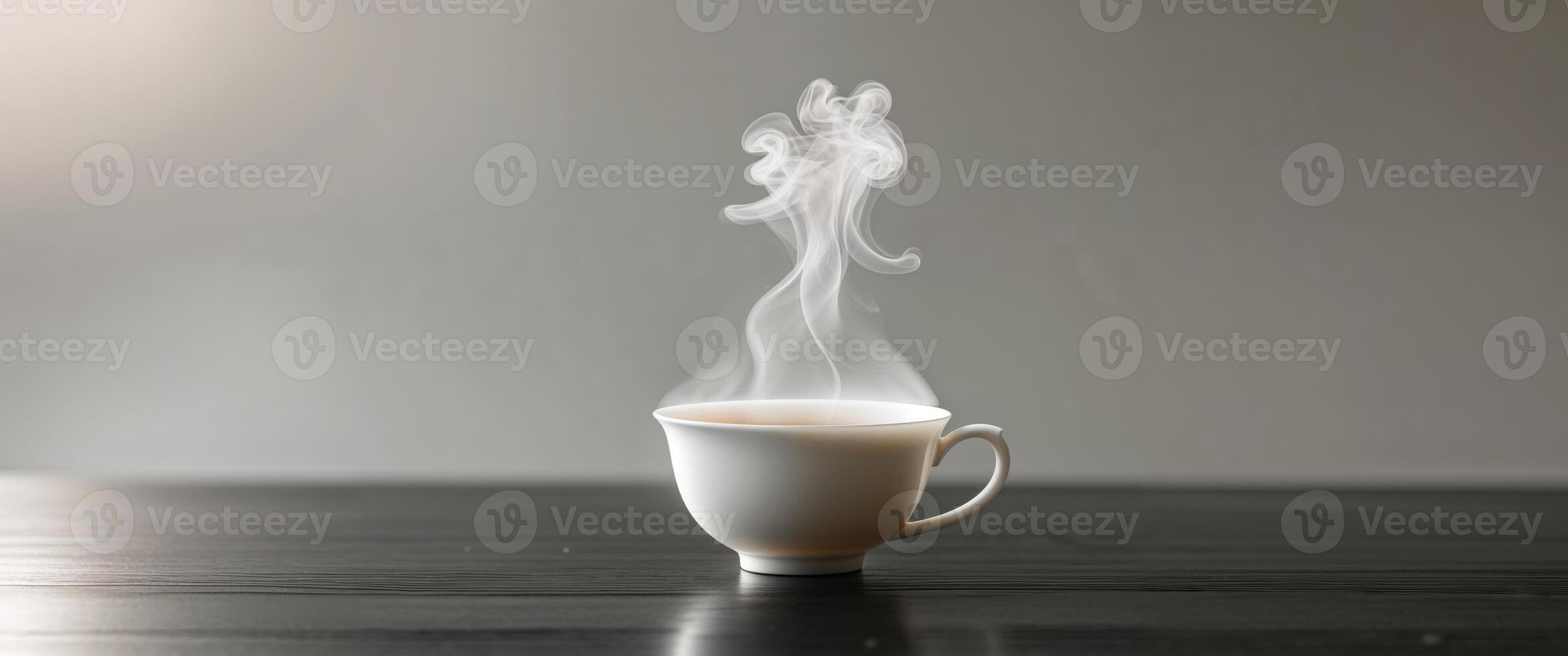 Steaming Cup of Tea on Dark Tabletop with Rising Vapor. photo