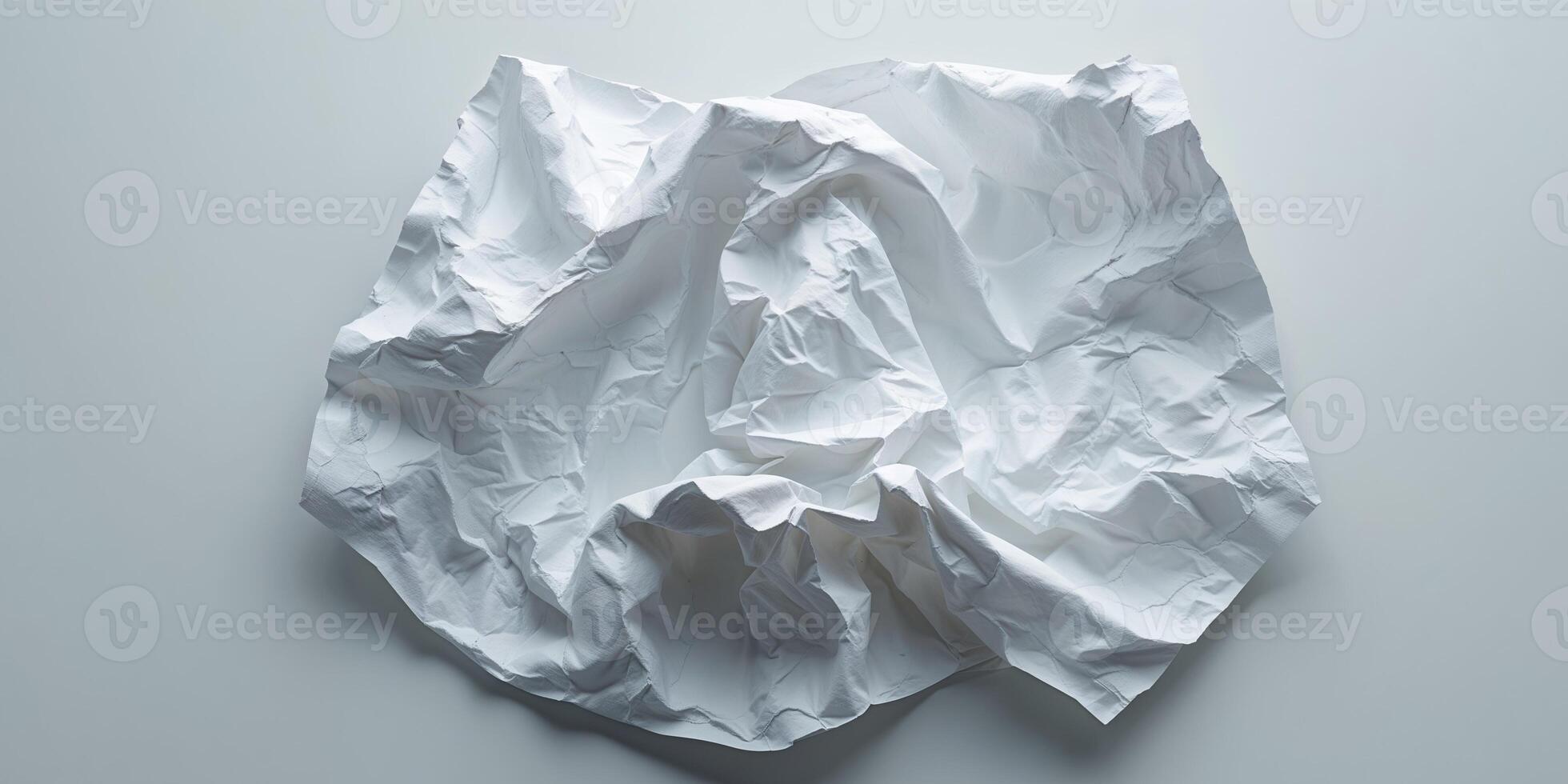 White crumpled paper with textured wrinkles and creases on a blank background photo