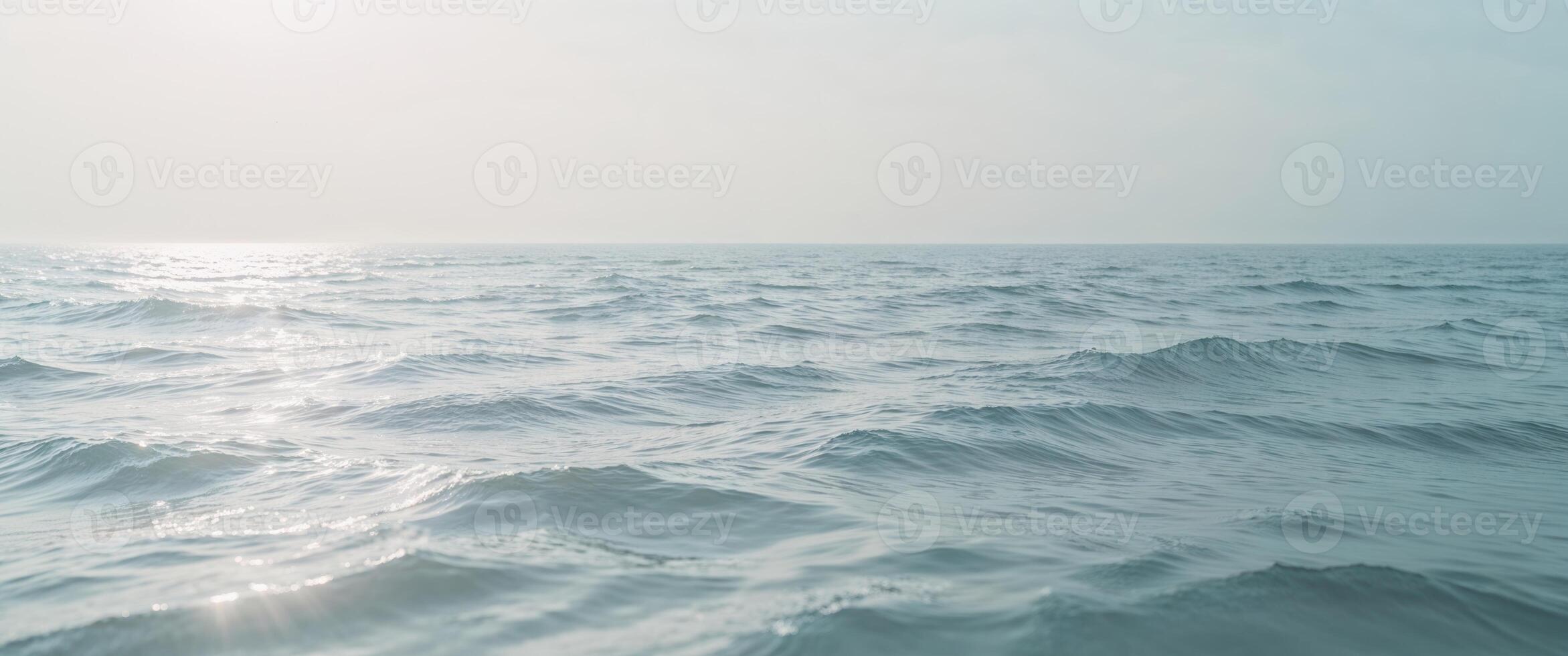 A view of the ocean with waves and sun photo