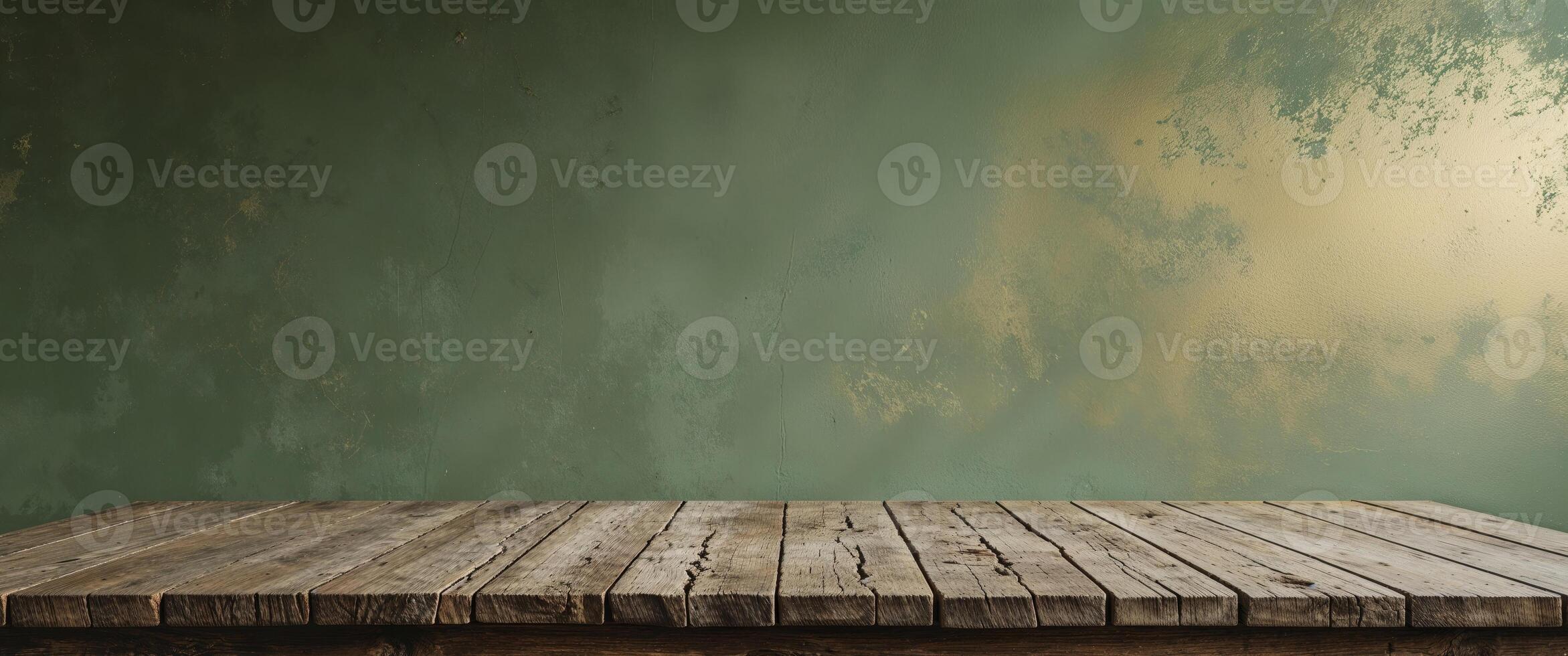 An empty table in front of a green wall photo