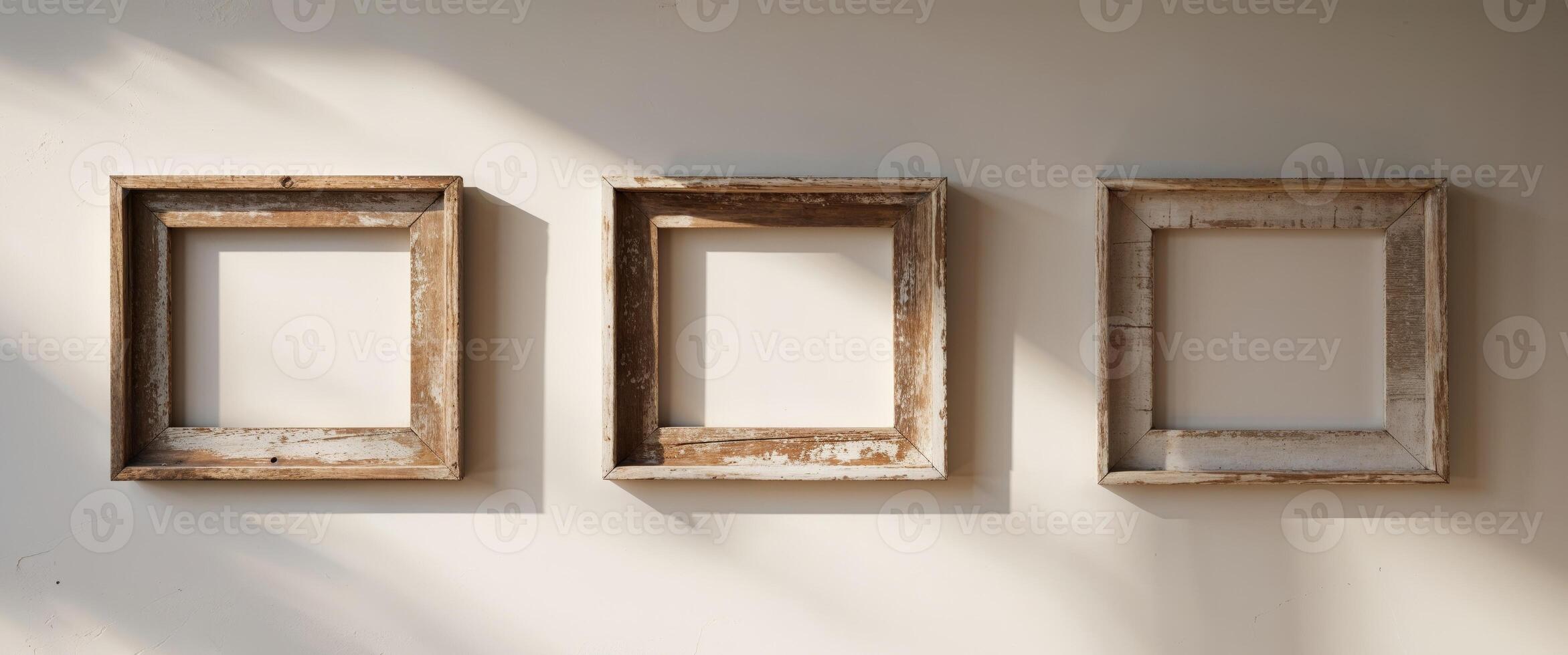 Four Rustic Square Wooden Frames on White Wall. photo
