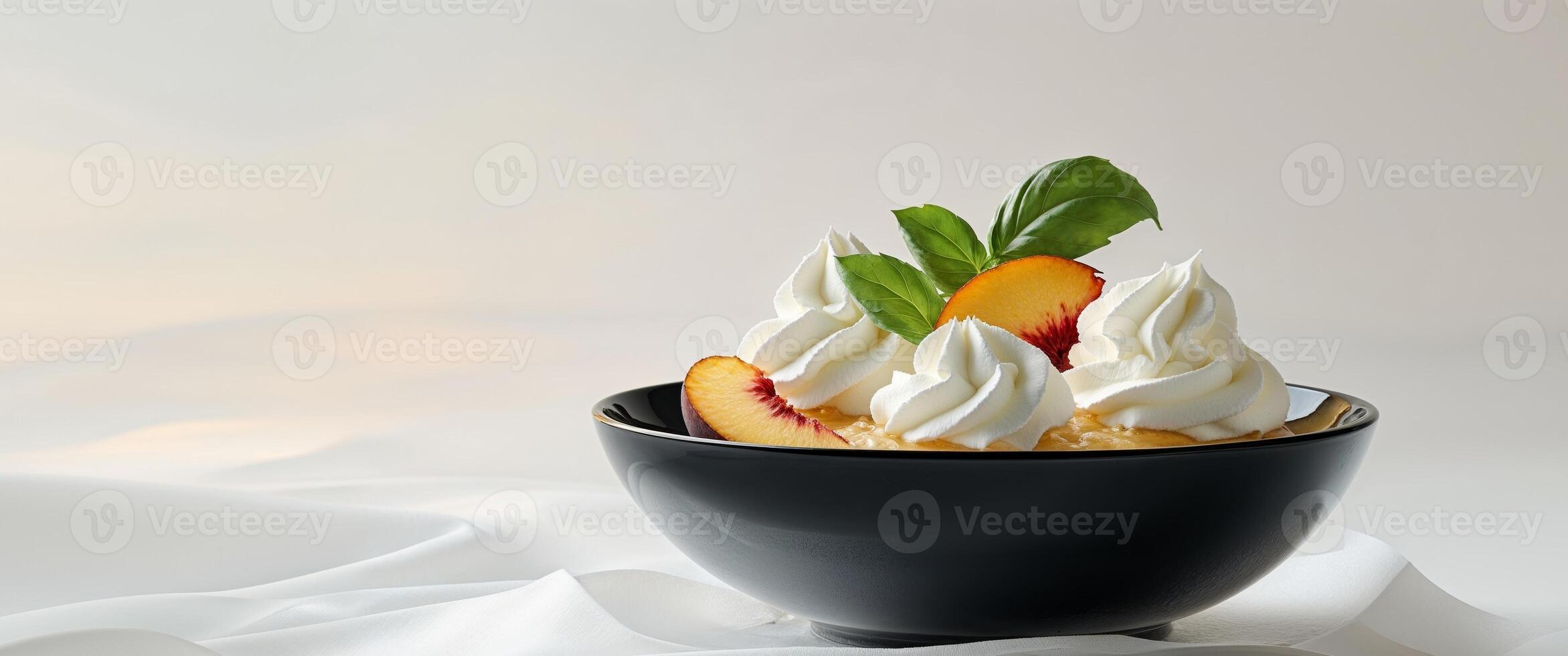 A bowl of ice cream with whipped cream and peaches photo