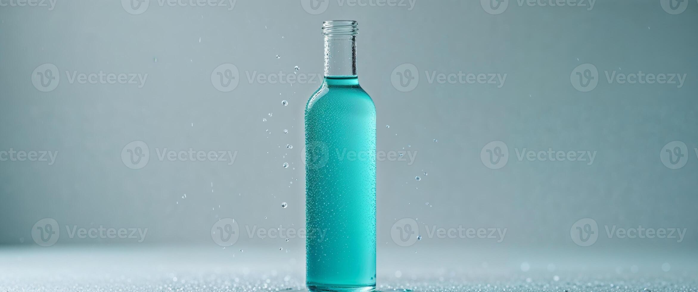 A blue liquid in a glass bottle with water drops photo