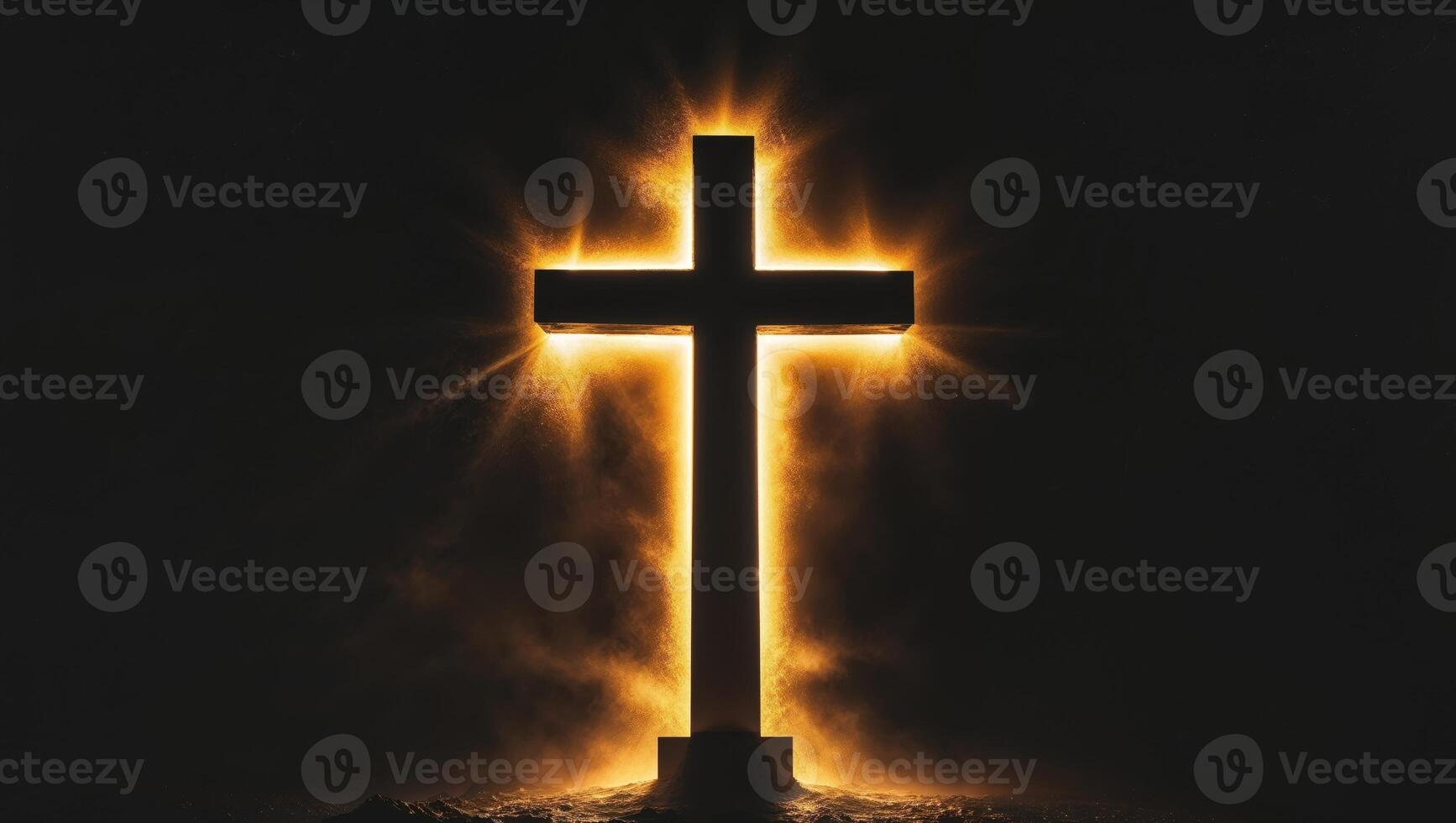 Cross silhouette illuminated by golden light in a dark setting photo