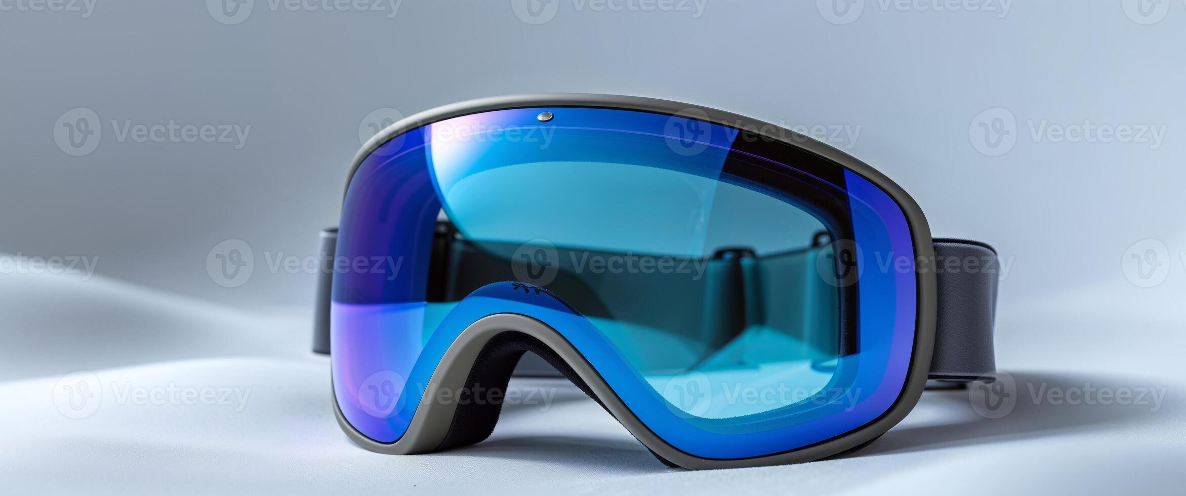 A pair of goggles with blue lenses on a white surface photo