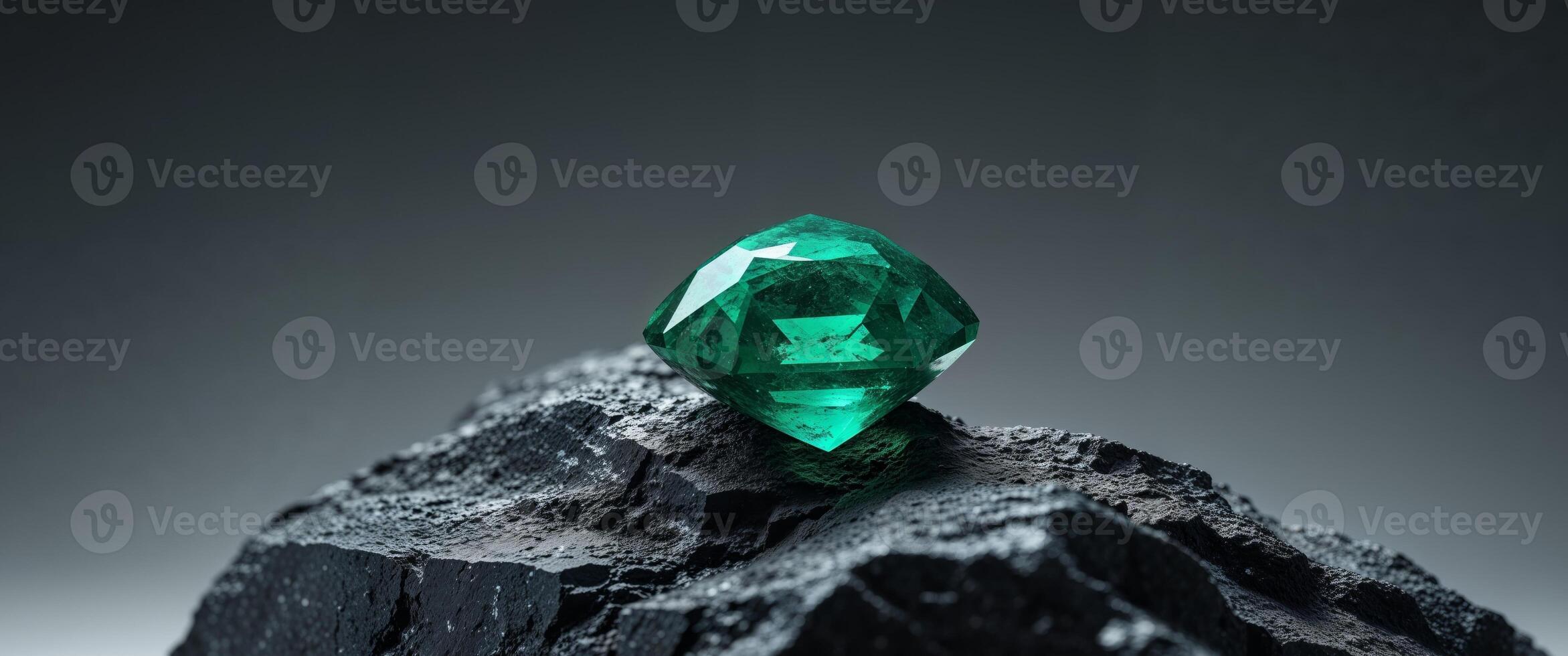Glowing Emerald Gemstone Embedded In Dark Rock photo