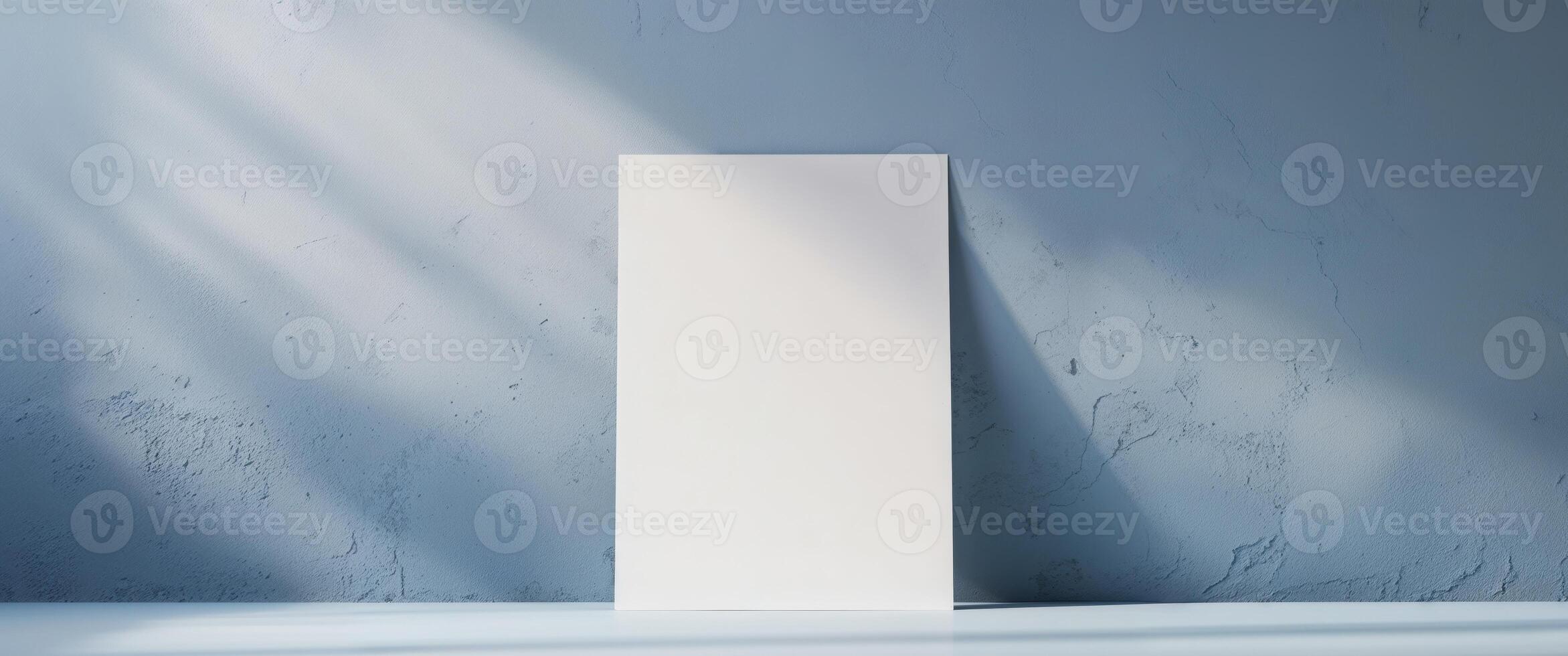Blank white board on a blue wall photo