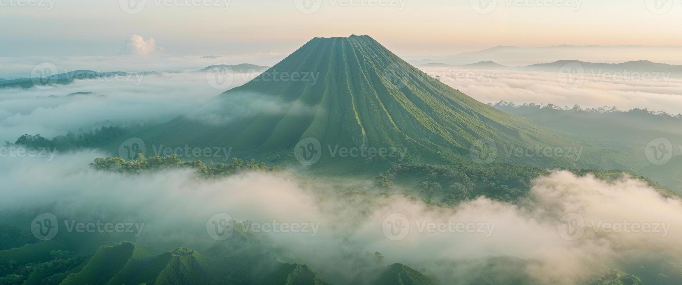 A mountain covered in green vegetation and clouds photo
