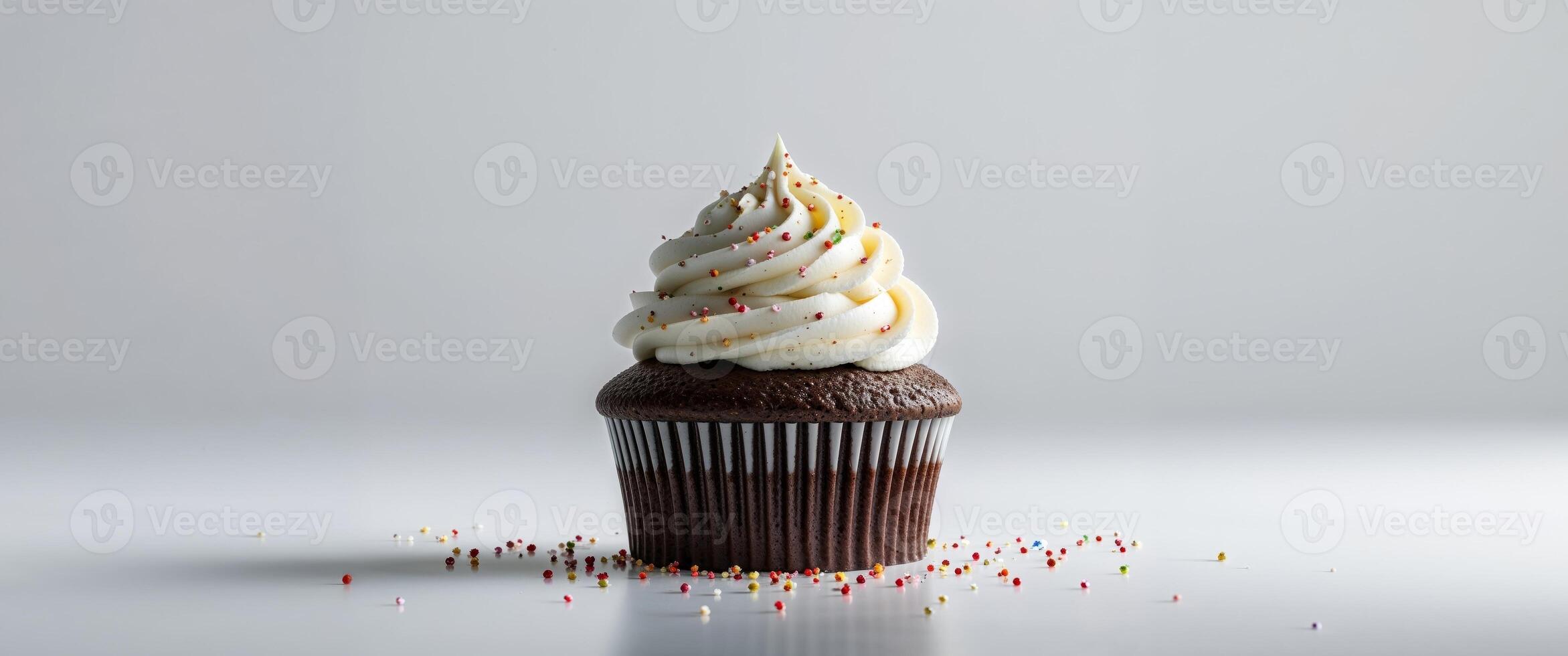 A Delicious Chocolate Cupcake Topped With Swirled Frosting Sprinkles. photo