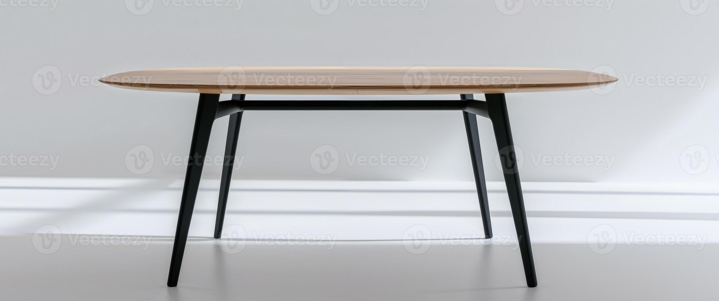 A wooden table with black legs and a round top photo