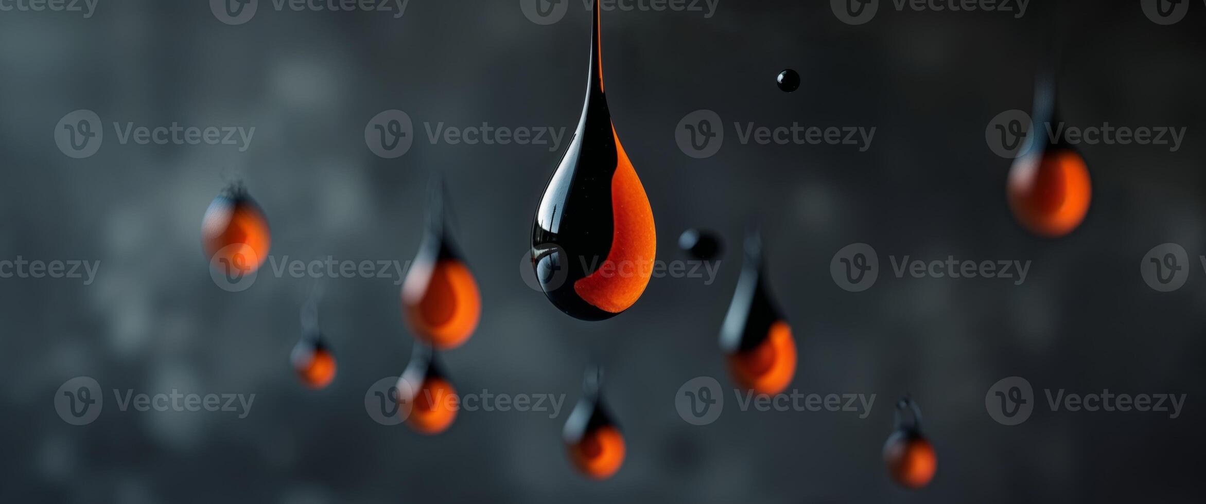 Abstract Orange and Black Liquid Drops on Dark Textured Background photo