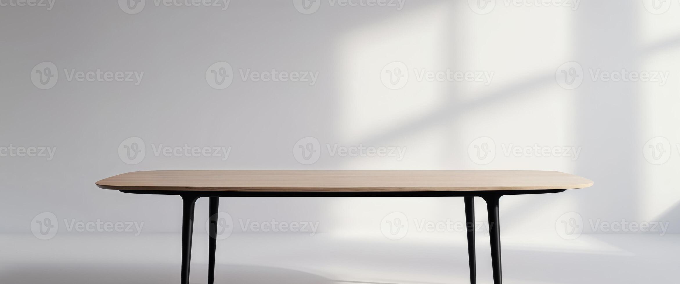A wooden table with black legs and a round top. photo