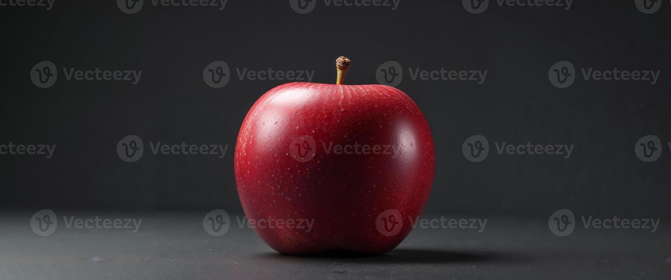 Red Apple with Unique Butt Shape on Black Background Still Life. photo