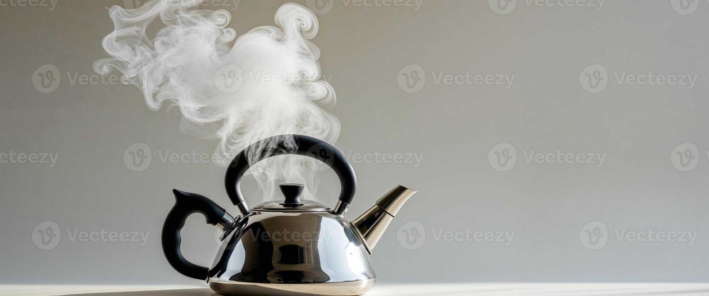 Steam coming out of a kettle on a table photo