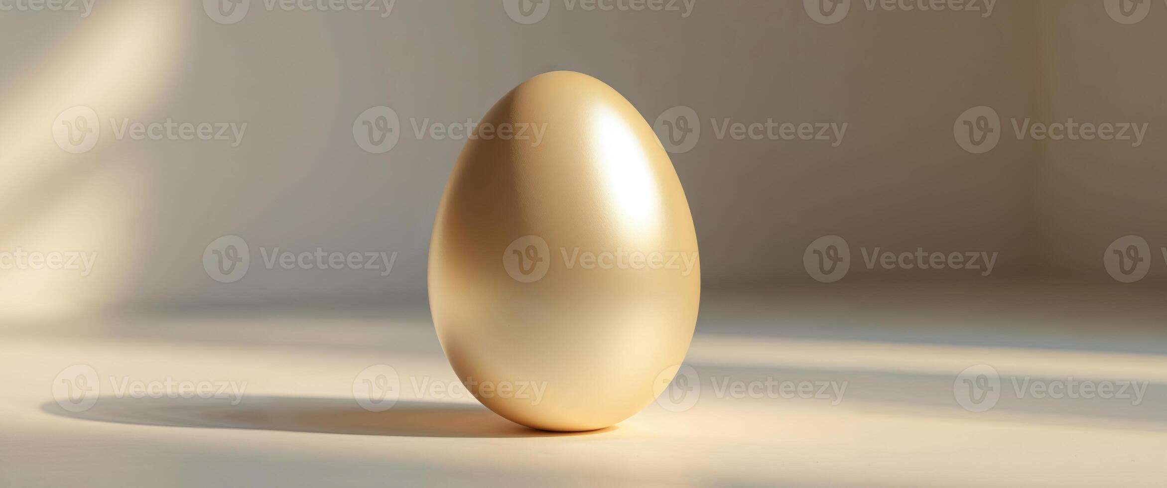 Smooth golden egg resting on a clean surface in soft lighting showcasing its simple elegance photo