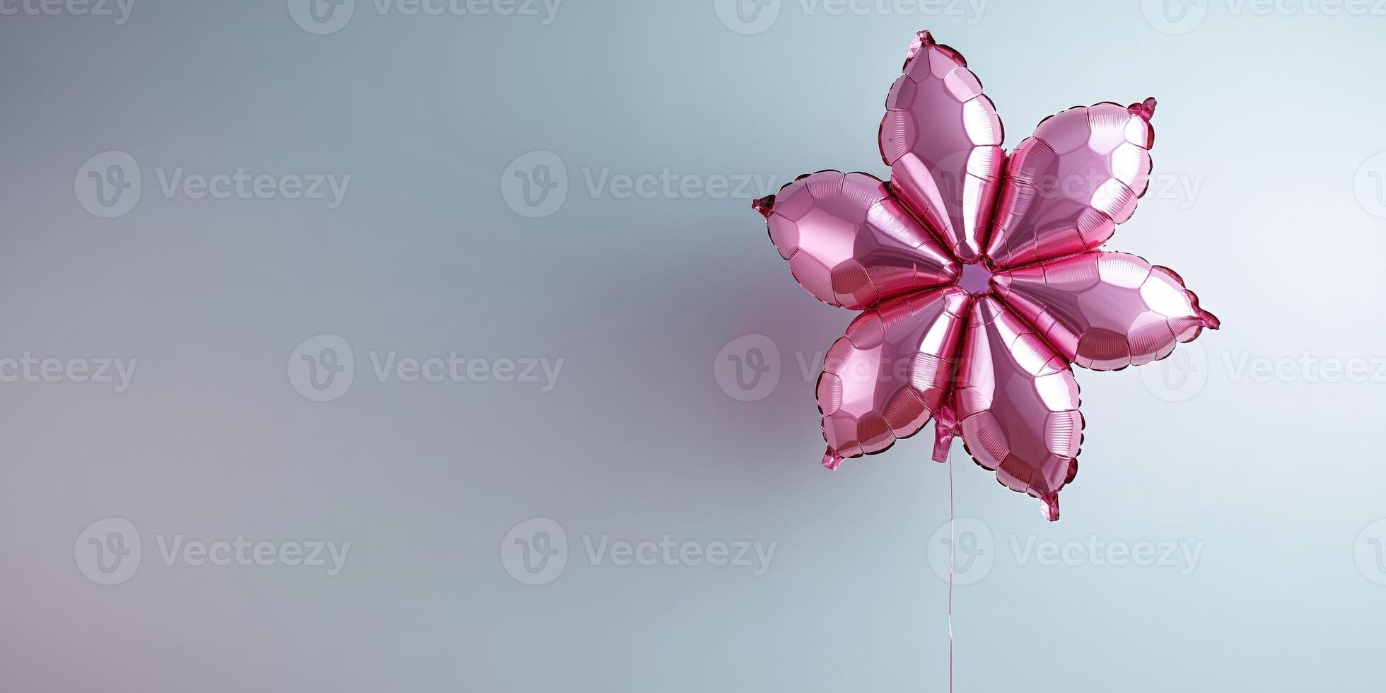 A pink balloon with a flower shape on it photo