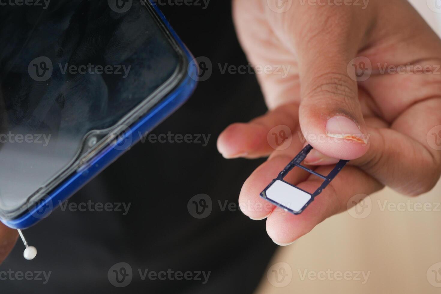 Inserting a SIM card into a smartphone at home photo