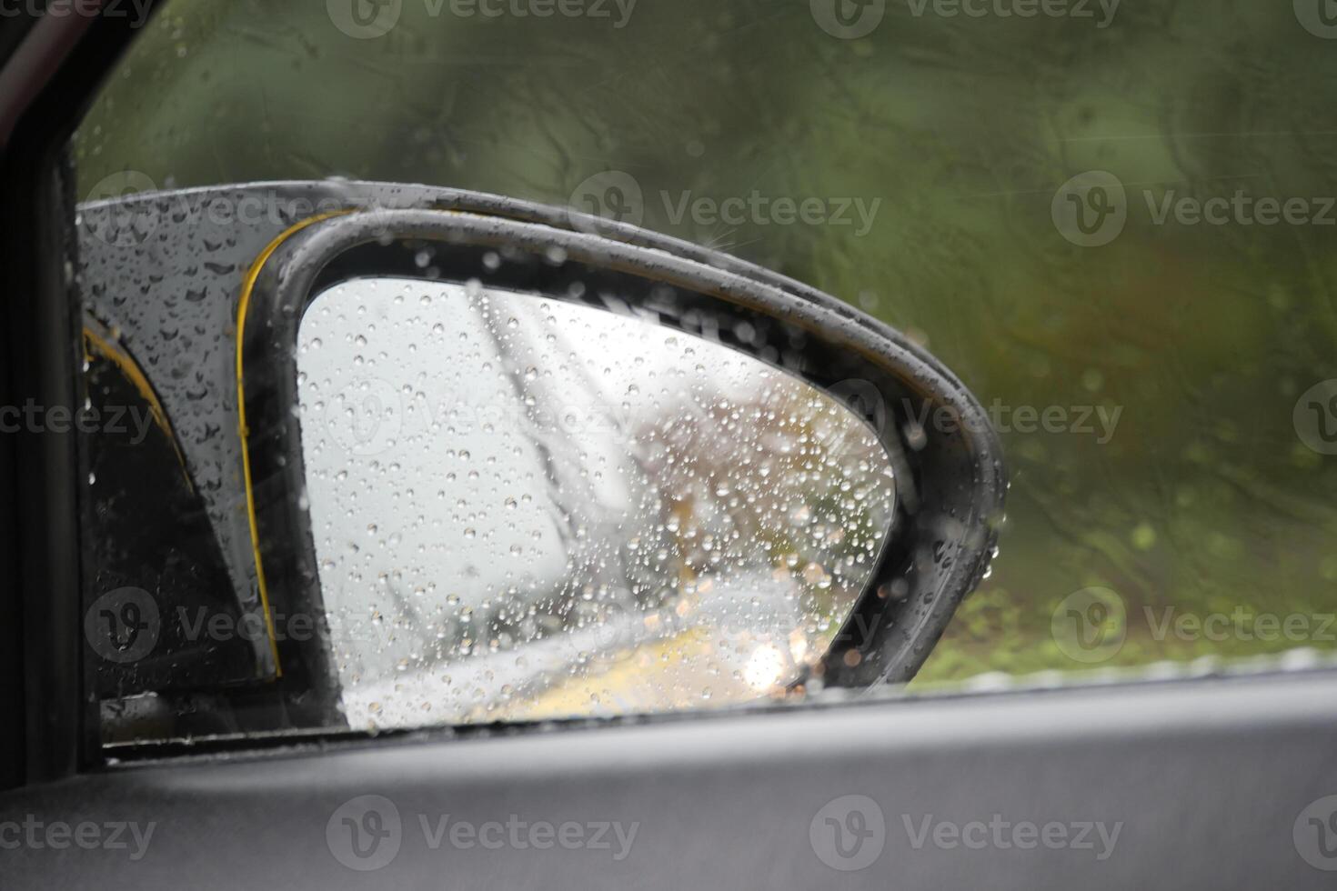 Rainy day view from a car side mirror in a tranquil setting photo