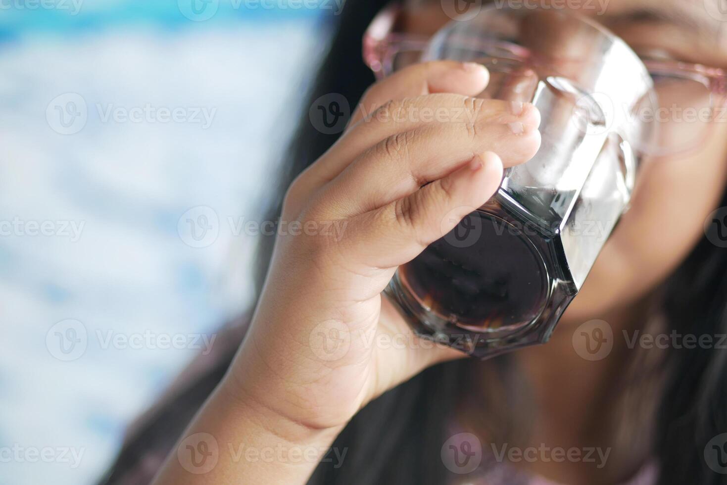 little girl enjoying a refreshing drink on a sunny day photo