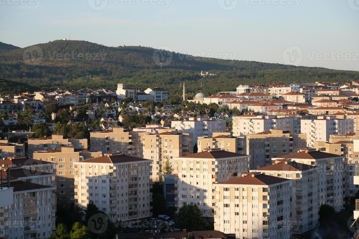 Cityscape view of residential buildings and mountains in daylight photo