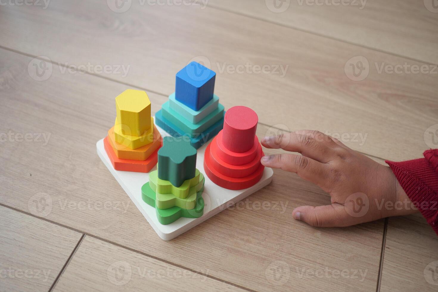 Colorful stacking toys engaging a young child's interest indoors photo