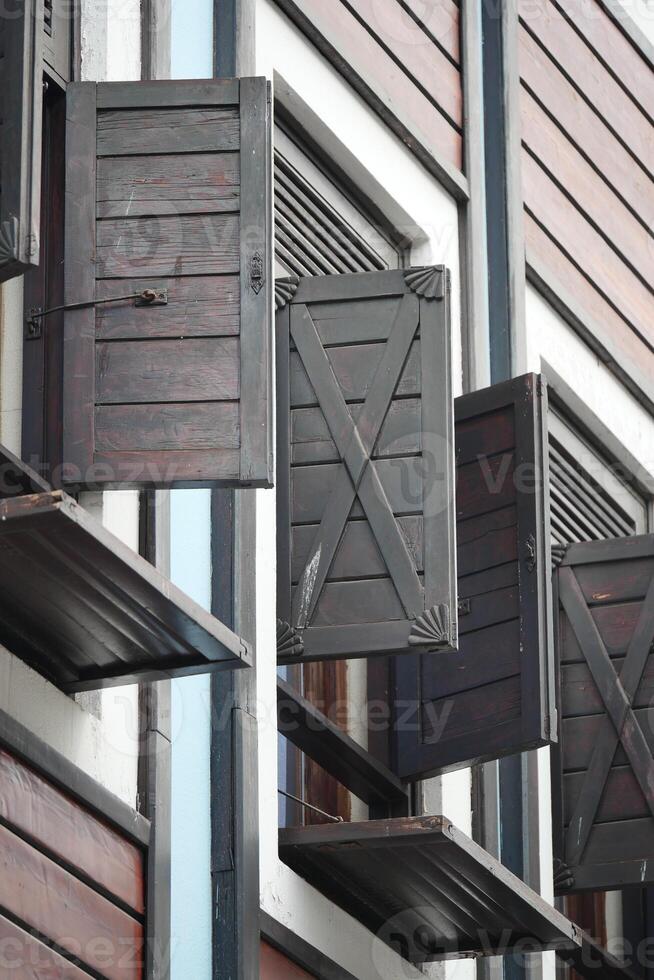 Shuttered windows on a rustic building in a vibrant neighborhood photo