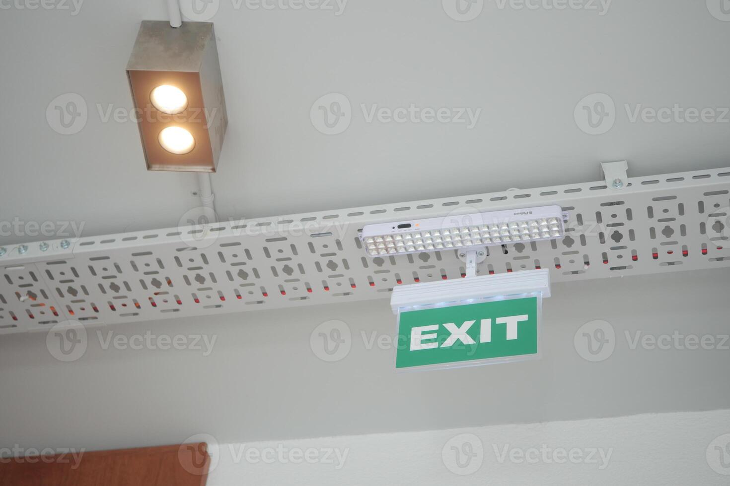 Emergency exit sign illuminated in a modern indoor space photo