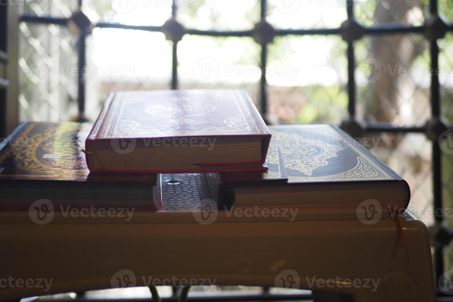 quran resting on a small table in a mosque photo