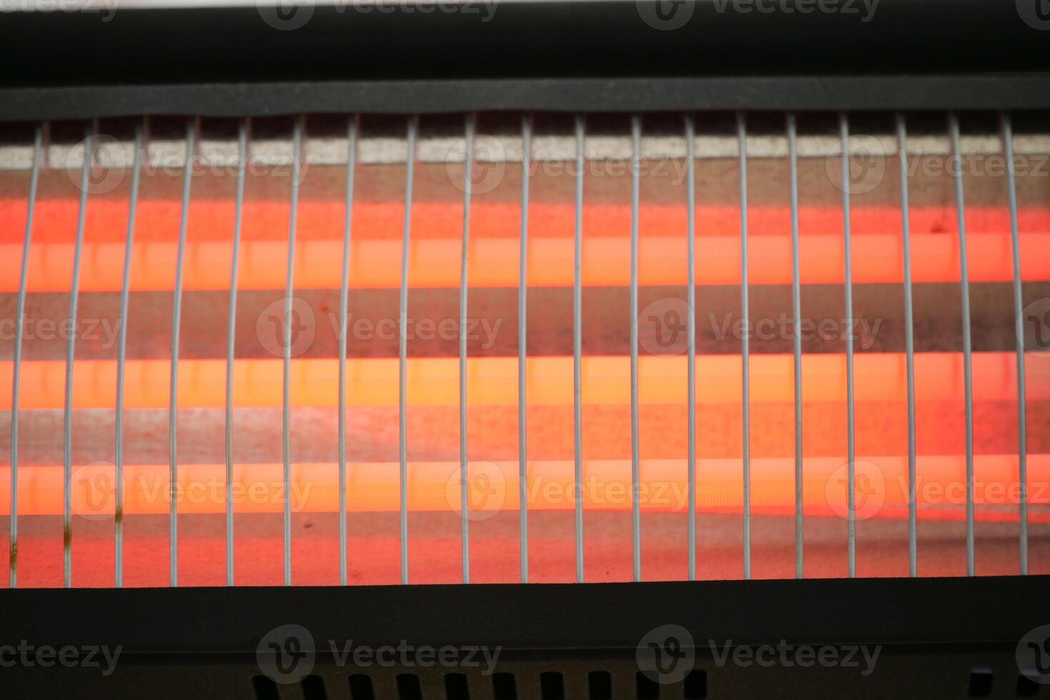 Electric heater glowing with warmth during winter evenings indoors photo