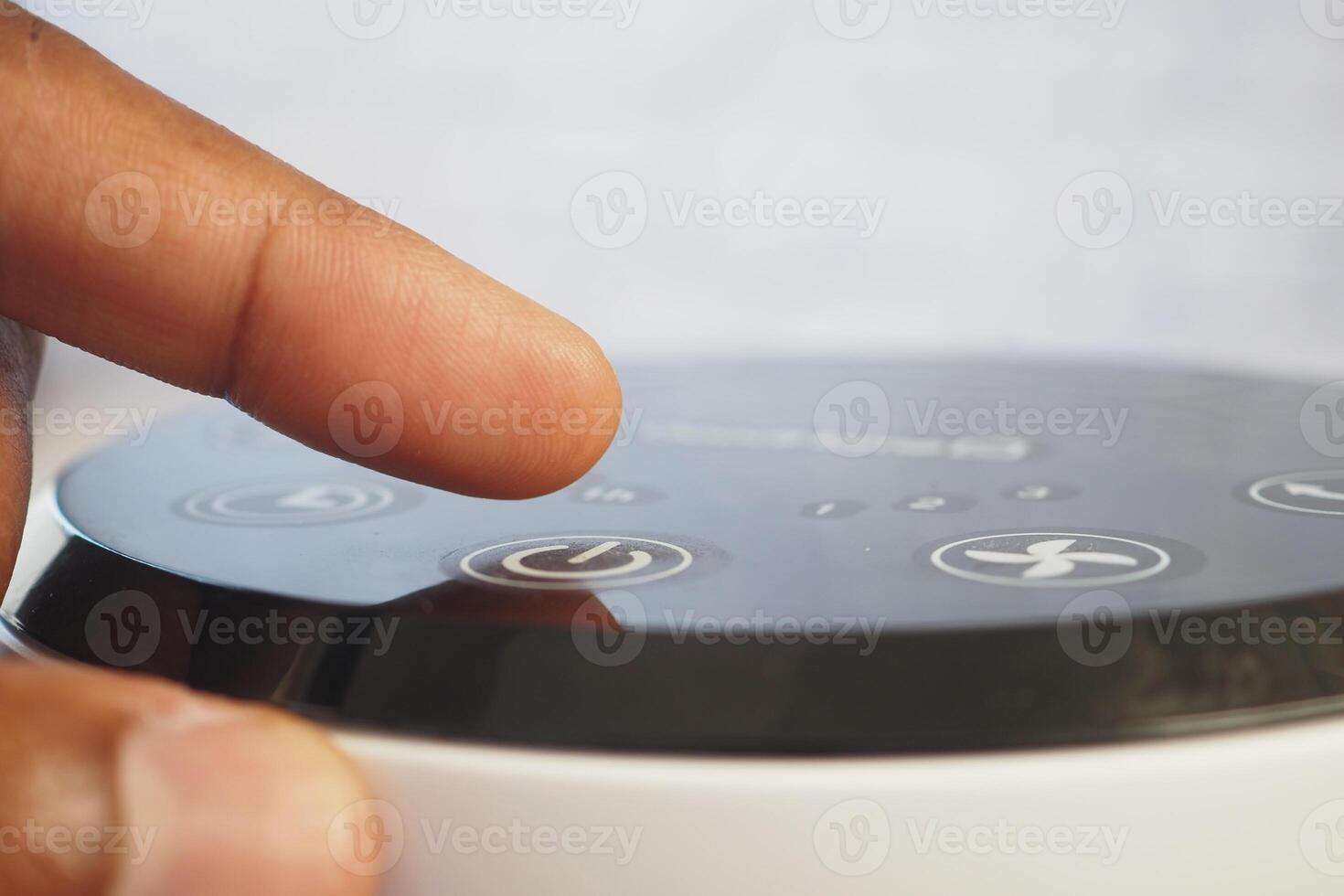 Adjusting settings on a modern device at home during the day photo