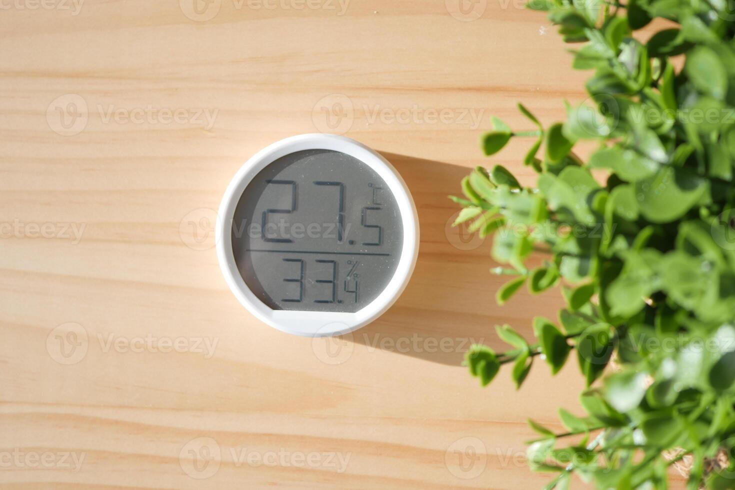 Digital thermometer displays temperature in a cozy indoor setting photo
