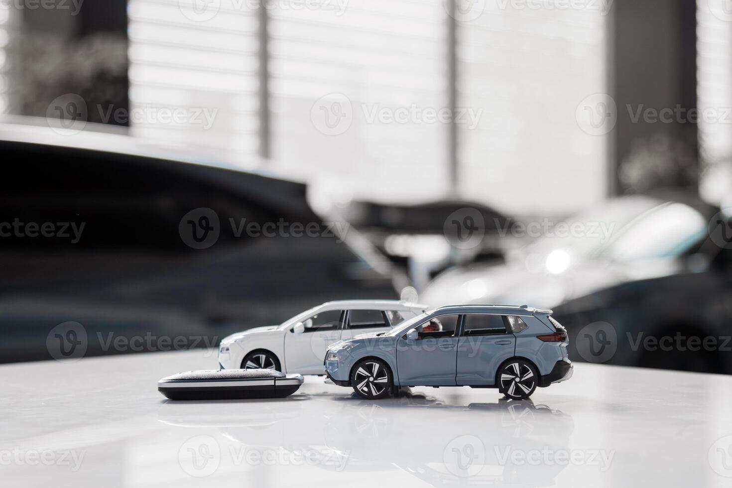 Two small car model toys is placed on a table against dealership background. Premium car buying experience that combines expert guidance with high-class service in an elegant setting. Advertising photo