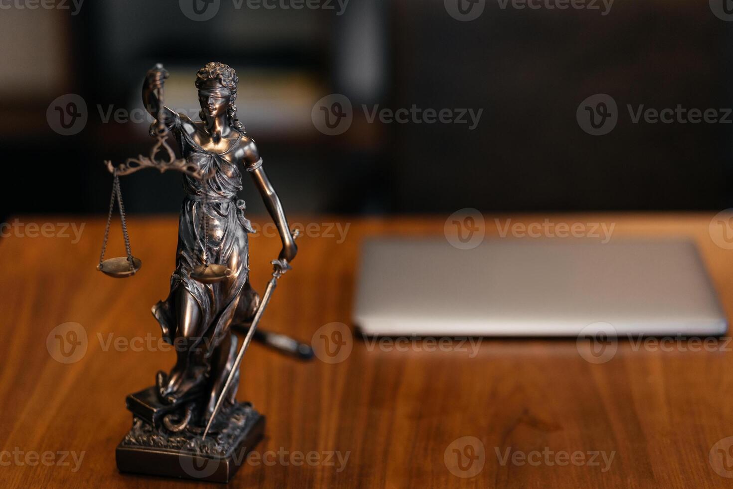 Golden lady justice statue is displayed on a wooden desk in a law office, symbolizing justice, fairness, and the legal system. Statue of Themis with a pair of scales of justice. Banner advertising photo